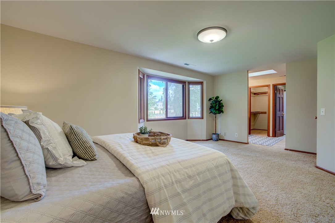 18322 Bellflower Road Bothell, WA 98012 - Photo 28 of 34 a bedroom with a bed and a potted plant