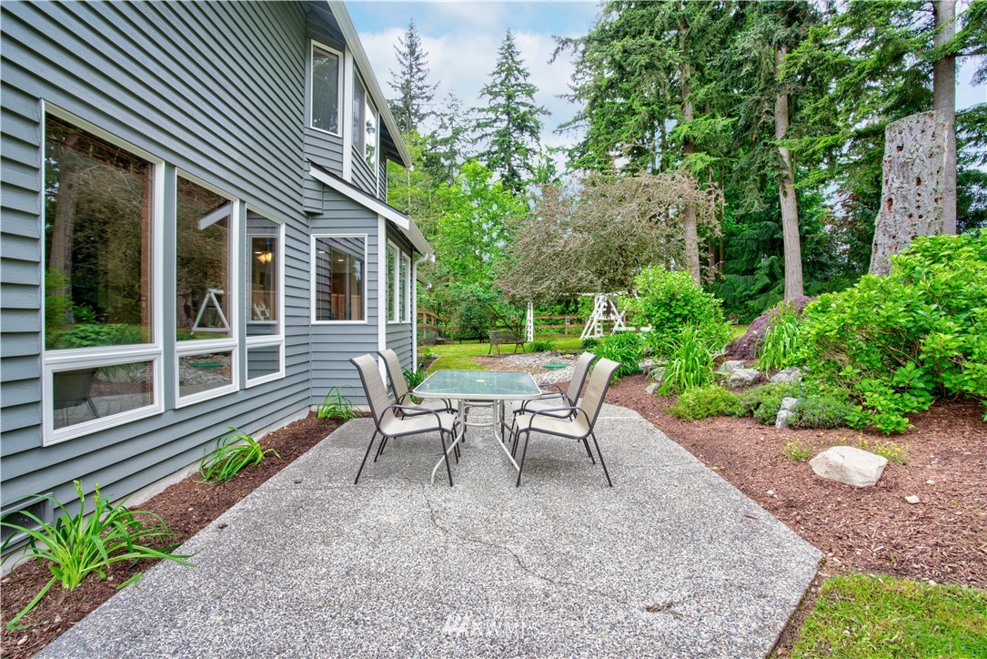 18322 Bellflower Road Bothell, WA 98012 - Photo 4 of 34 a view of a house with a backyard and sitting area