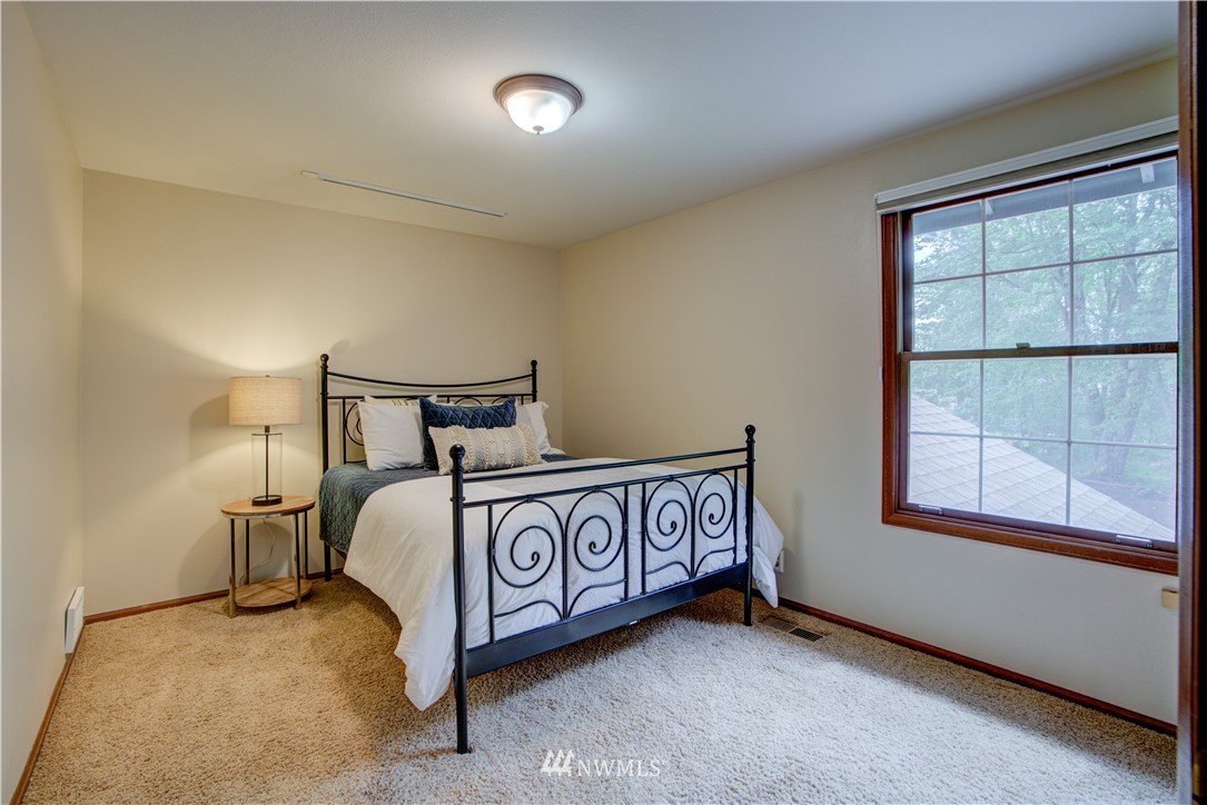 18322 Bellflower Road Bothell, WA 98012 - Photo 31 of 34 a bedroom with a bed and window