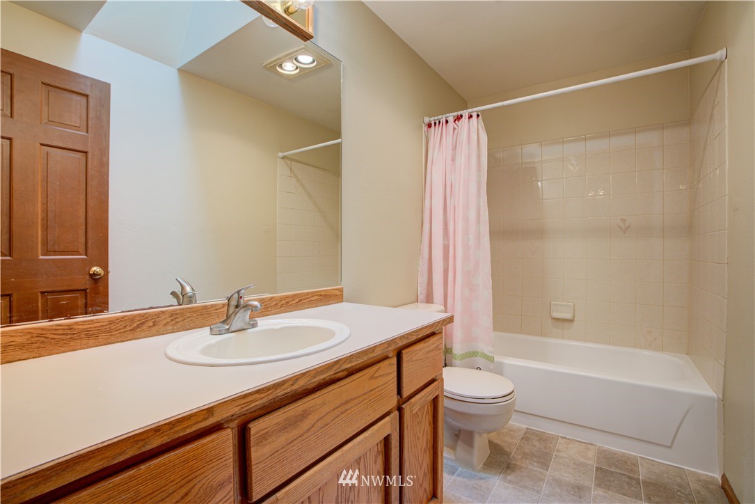 18322 Bellflower Road Bothell, WA 98012 - Photo 34 of 34 a bathroom with a sink a toilet and shower