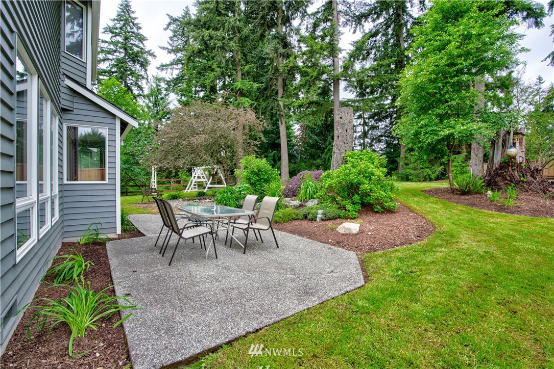 18322 Bellflower Road Bothell, WA 98012 - Photo 7 of 34 a view of a back yard of the house with a patio