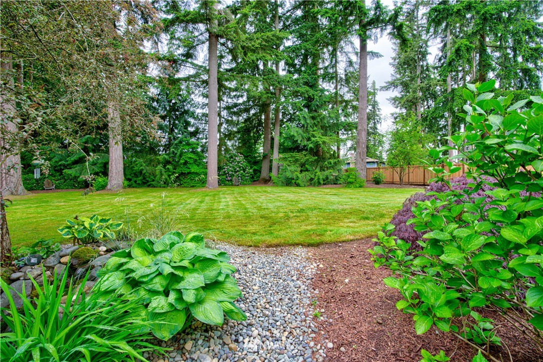 18322 Bellflower Road Bothell, WA 98012 - Photo 8 of 34 a view of a grassy field with trees