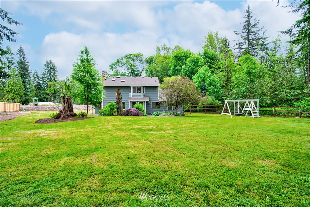 18322 Bellflower Road Bothell, WA 98012 - Photo 9 of 34 a view of a house with a yard
