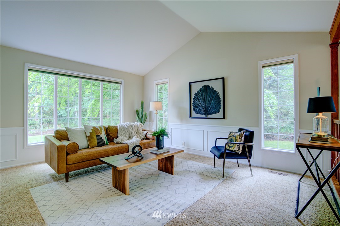 18322 Bellflower Road Bothell, WA 98012 - Photo 10 of 34 a living room with furniture and a flat screen tv