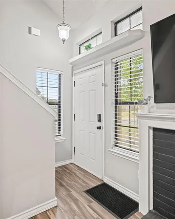 a view of entryway and hall with wooden floor