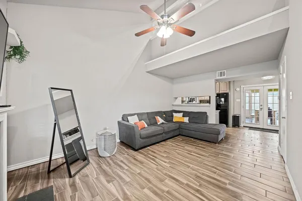 a living room with furniture and wooden floor