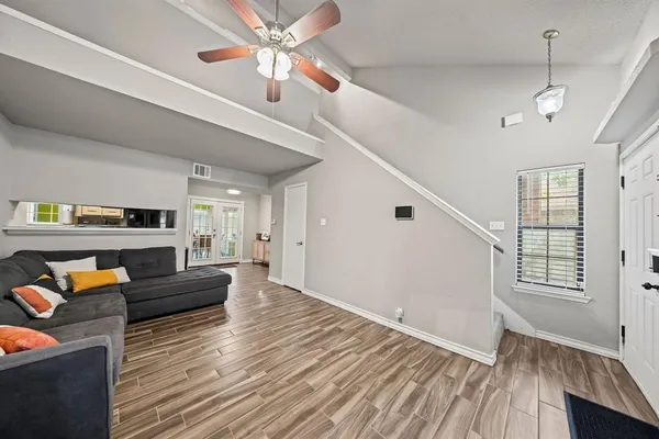 a living room with furniture a fireplace and a flat screen tv