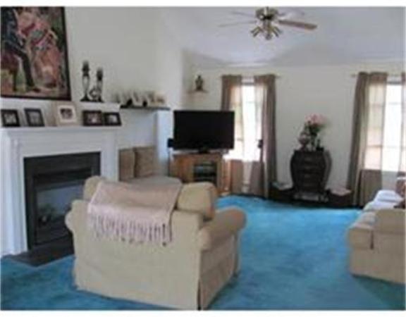 64 Andover Road Billerica, MA 01821 - Photo 4 of 6 a living room with furniture and a flat screen tv