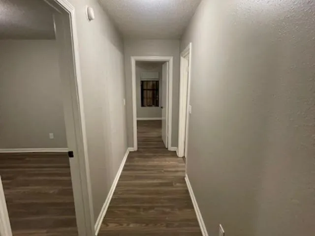 a kitchen with granite countertop a sink dishwasher stove and refrigerator