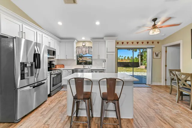 a kitchen with a sink stove and refrigerator