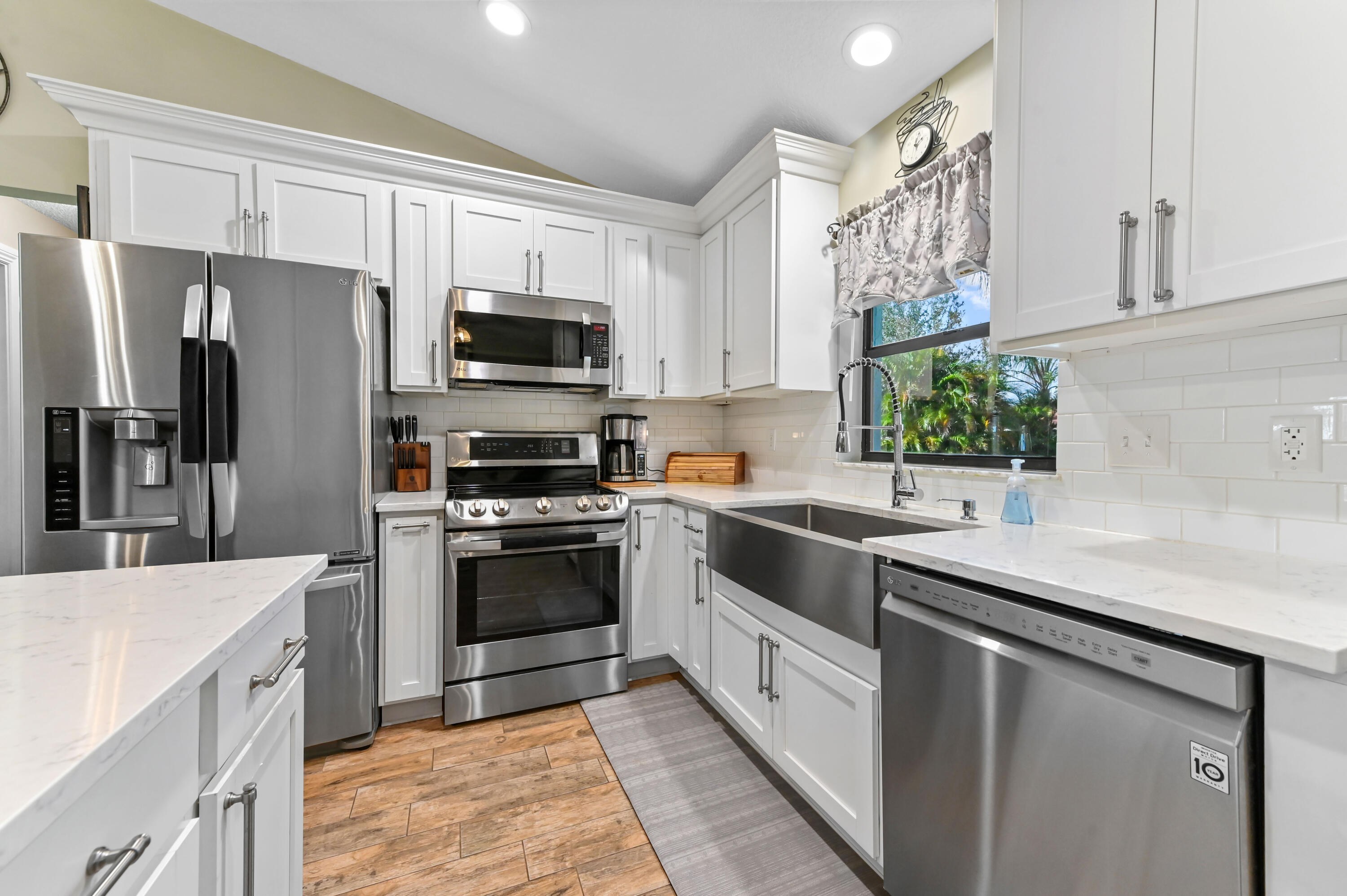 665 Southwest Backert Avenue Port St. Lucie, FL 34953 - Photo 14 of 46 a kitchen with a sink stove and refrigerator