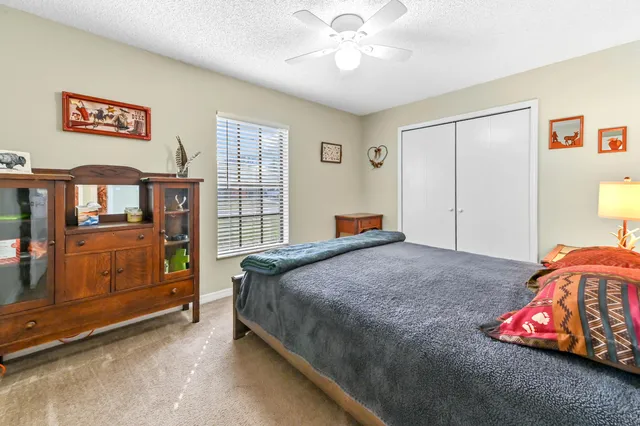 a bedroom with a bed and a dresser in it
