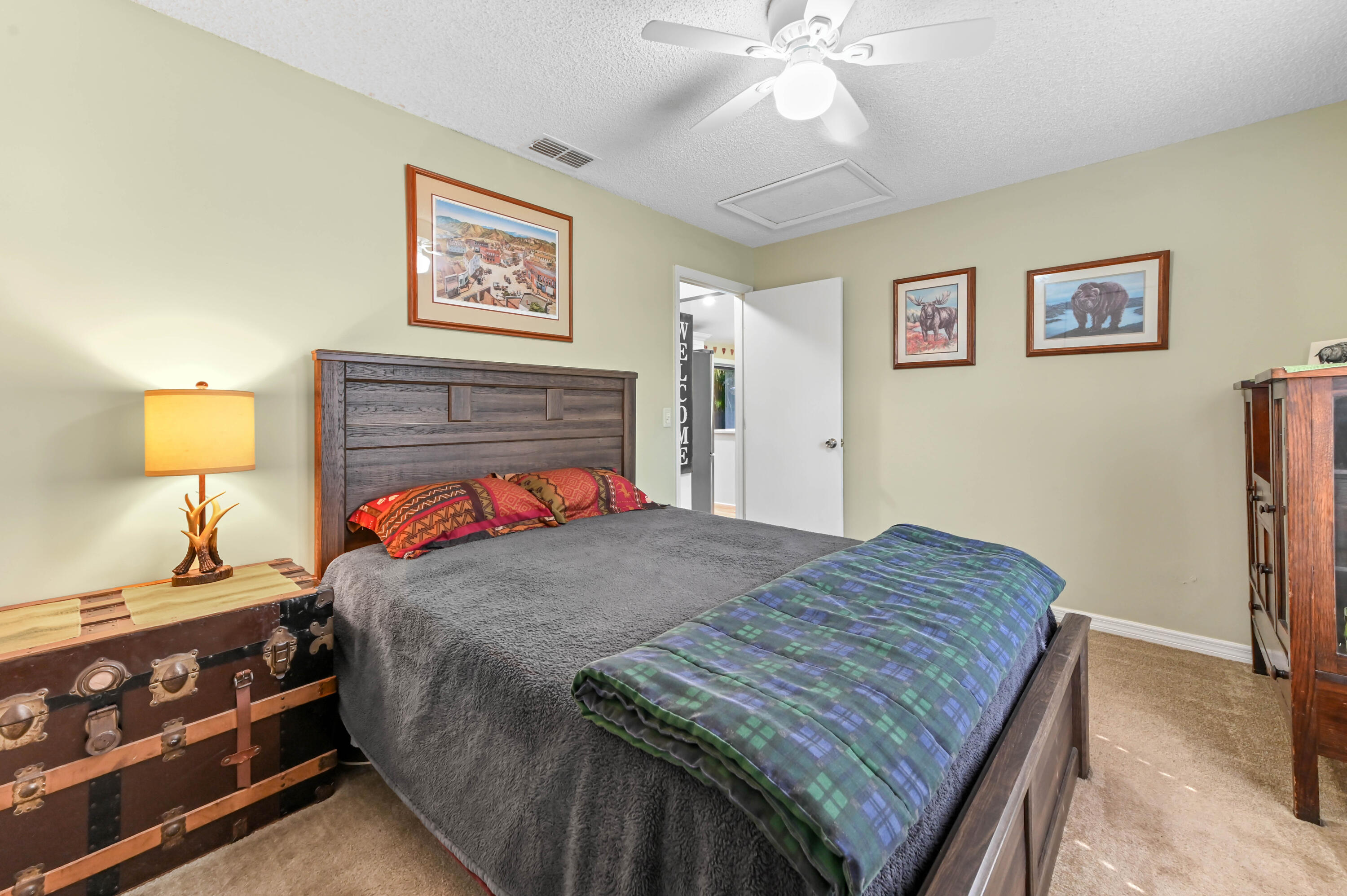 665 Southwest Backert Avenue Port St. Lucie, FL 34953 - Photo 18 of 46 a bedroom with a bed and a dresser in it