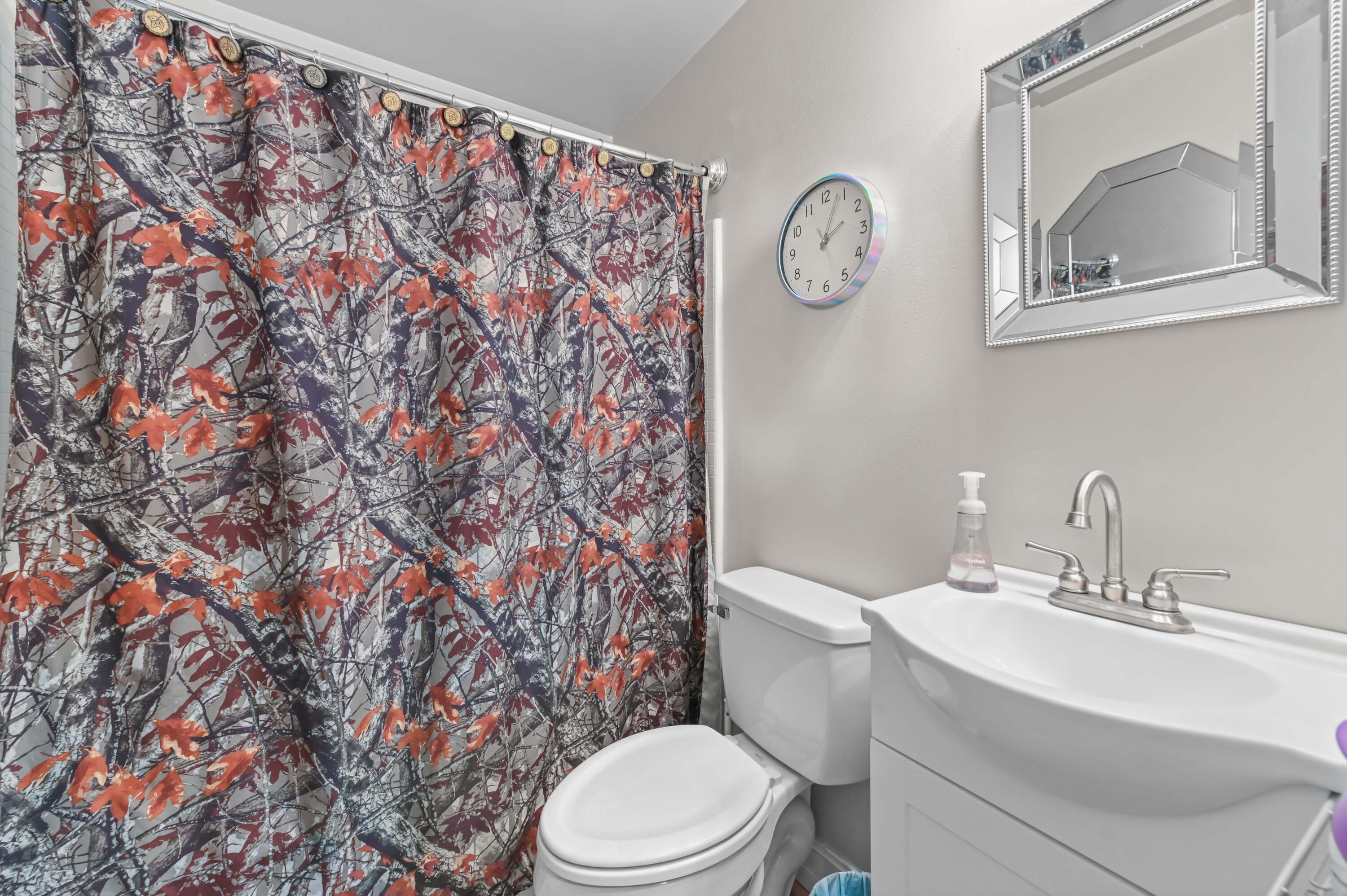 665 Southwest Backert Avenue Port St. Lucie, FL 34953 - Photo 21 of 46 a bathroom with a toilet and a sink