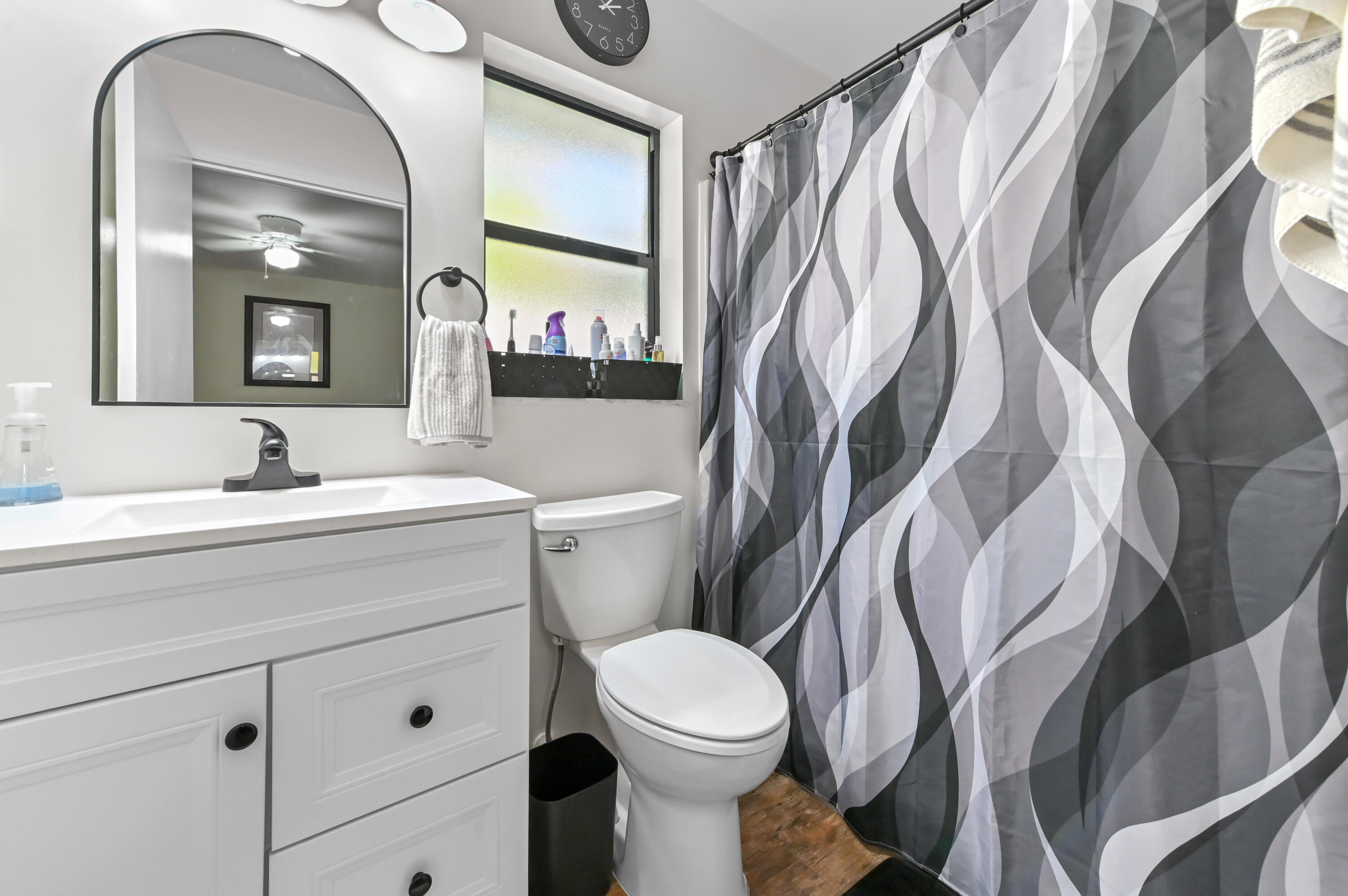 665 Southwest Backert Avenue Port St. Lucie, FL 34953 - Photo 24 of 46 a bathroom with a toilet sink and mirror