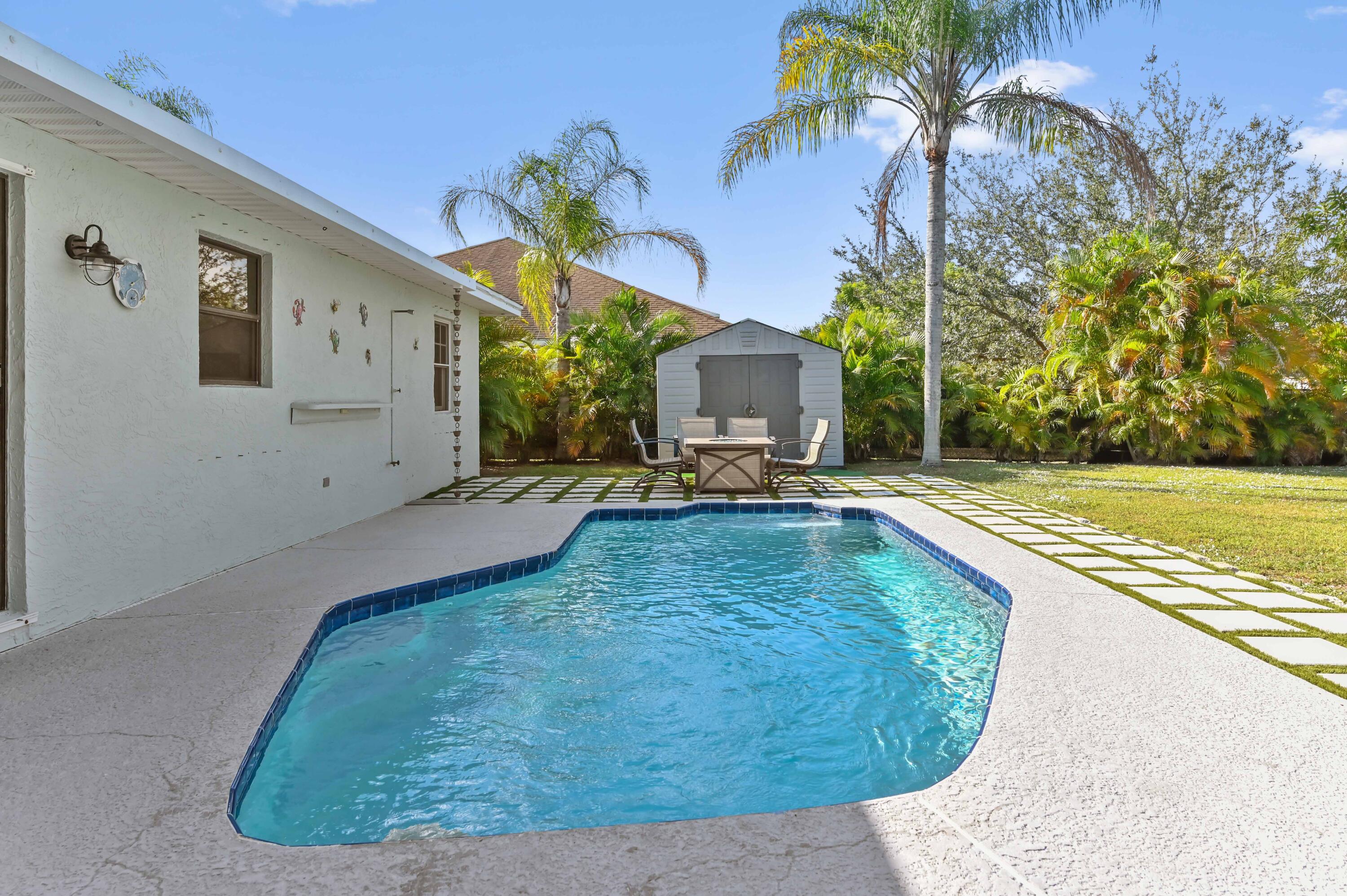 665 Southwest Backert Avenue Port St. Lucie, FL 34953 - Photo 26 of 46 a swimming pool with yard and outdoor seating