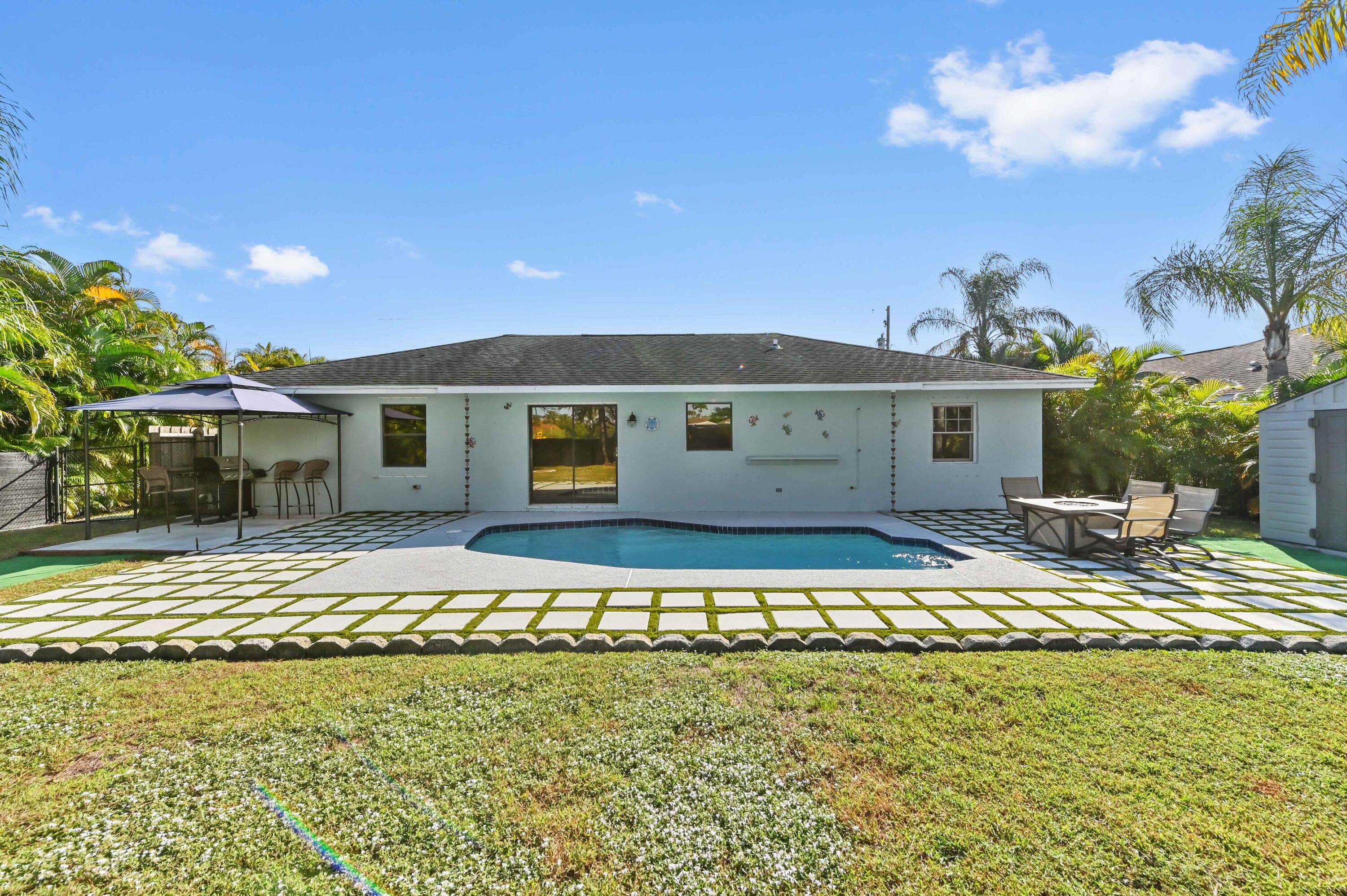 665 Southwest Backert Avenue Port St. Lucie, FL 34953 - Photo 28 of 46 a front view of a house with a yard