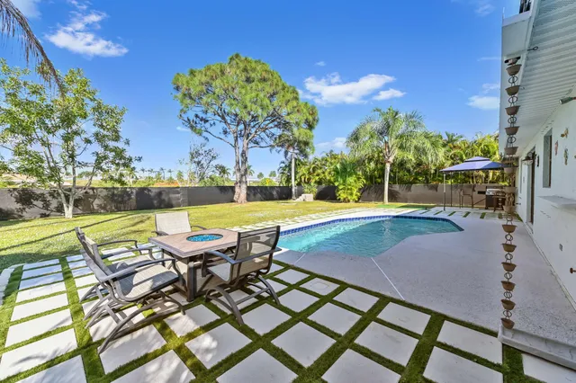 a view of a swimming pool with lounge chairs