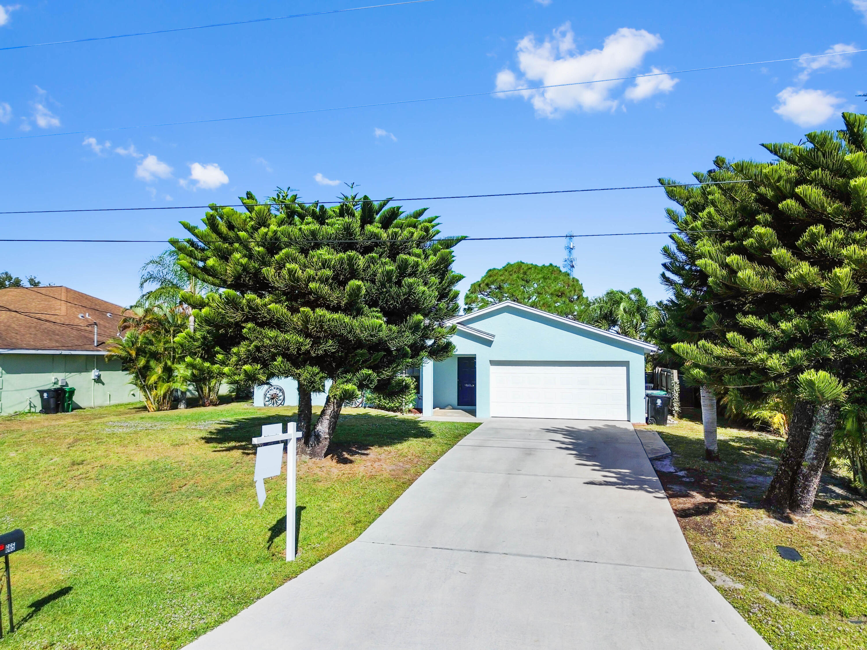 665 Southwest Backert Avenue Port St. Lucie, FL 34953 - Photo 35 of 46 a front view of a house with garden