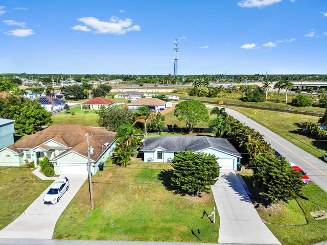 an aerial view of a house with a garden and swimming pool