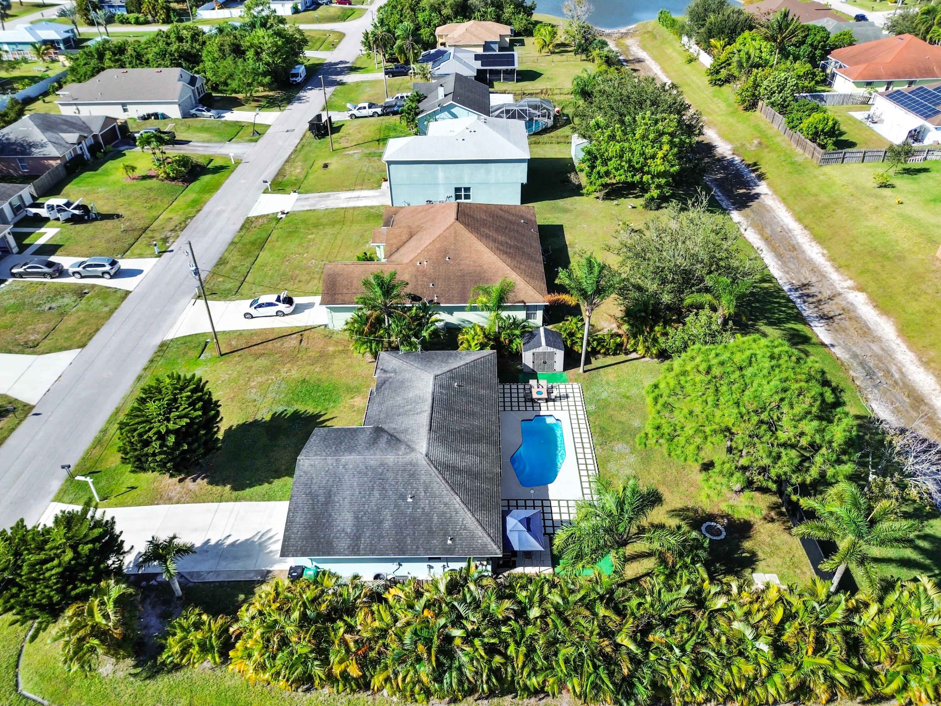 665 Southwest Backert Avenue Port St. Lucie, FL 34953 - Photo 37 of 46 an aerial view of a house with a garden and swimming pool