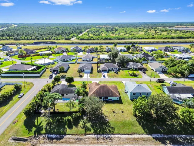 an aerial view of a house with a yard and garden