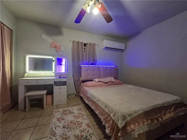 a bedroom with a bed and a desk