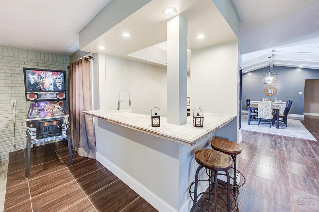 10213 Stewart Road Galveston, TX 77554 - Photo 13 of 49 a large room with lots of wooden furniture and a shower