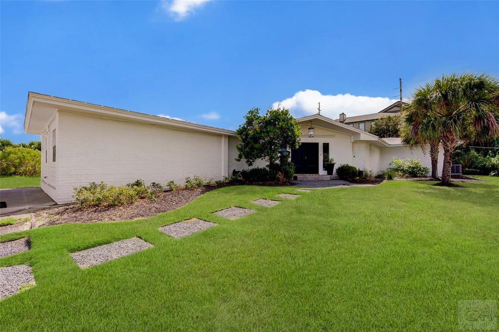 10213 Stewart Road Galveston, TX 77554 - Photo 2 of 49 a front view of house with garden