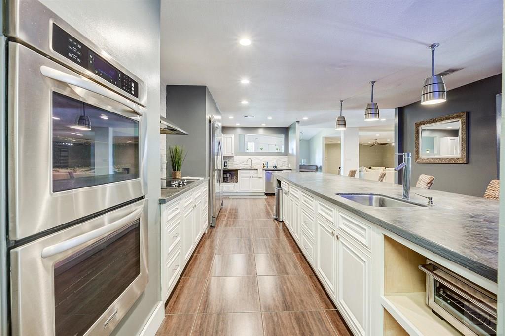 10213 Stewart Road Galveston, TX 77554 - Photo 22 of 49 a large kitchen with stainless steel appliances lots of counter space and a sink