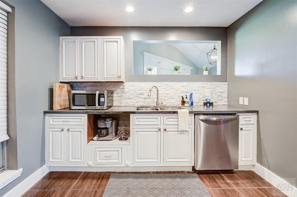 10213 Stewart Road Galveston, TX 77554 - Photo 23 of 49 a kitchen with stainless steel appliances granite countertop a sink stove and cabinets