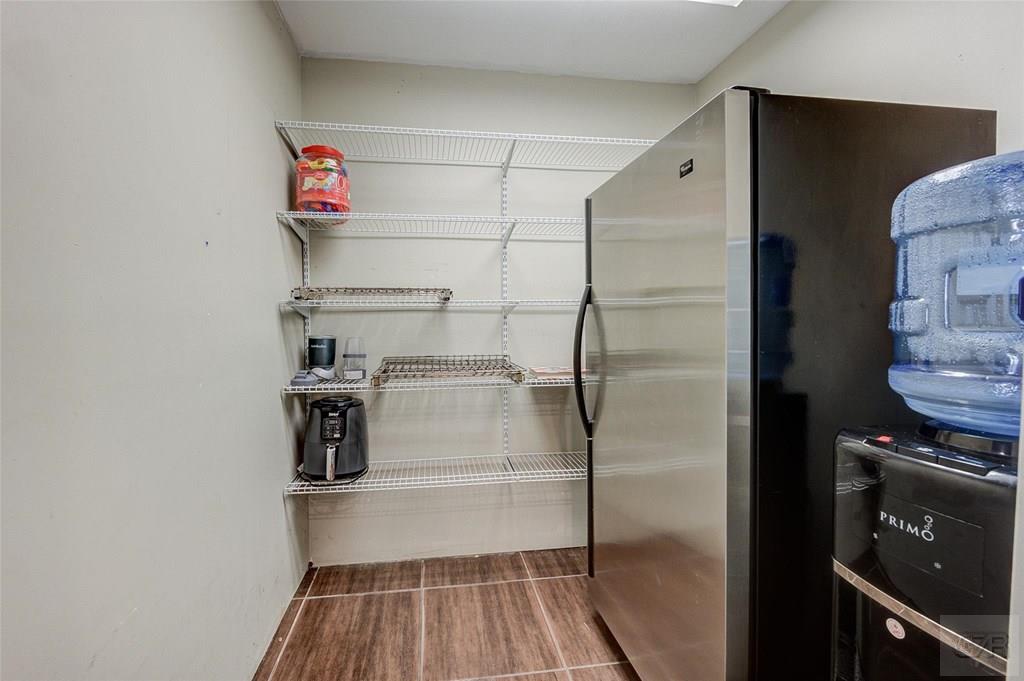 10213 Stewart Road Galveston, TX 77554 - Photo 25 of 49 a storage room with washer and dryer