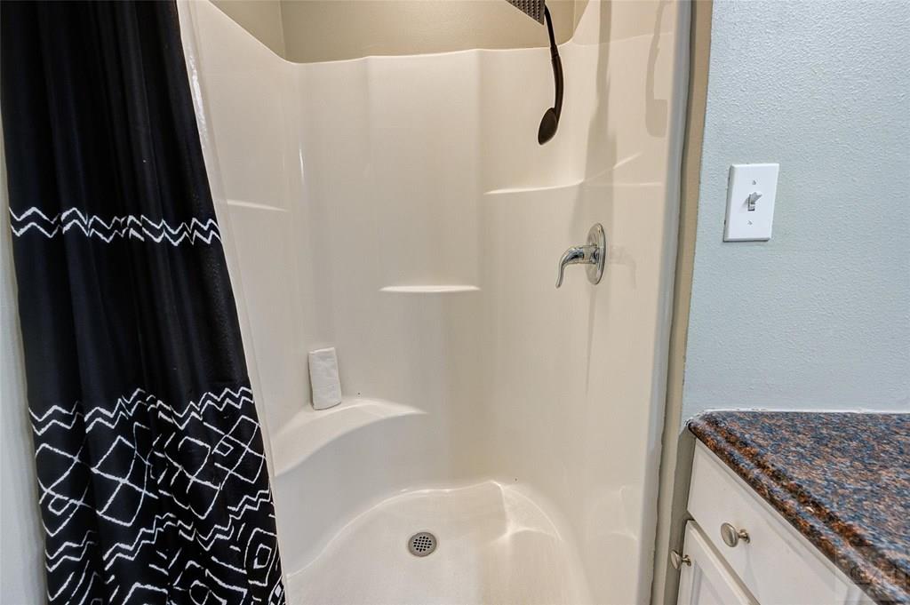 10213 Stewart Road Galveston, TX 77554 - Photo 30 of 49 a bathroom with a bathtub and a shower