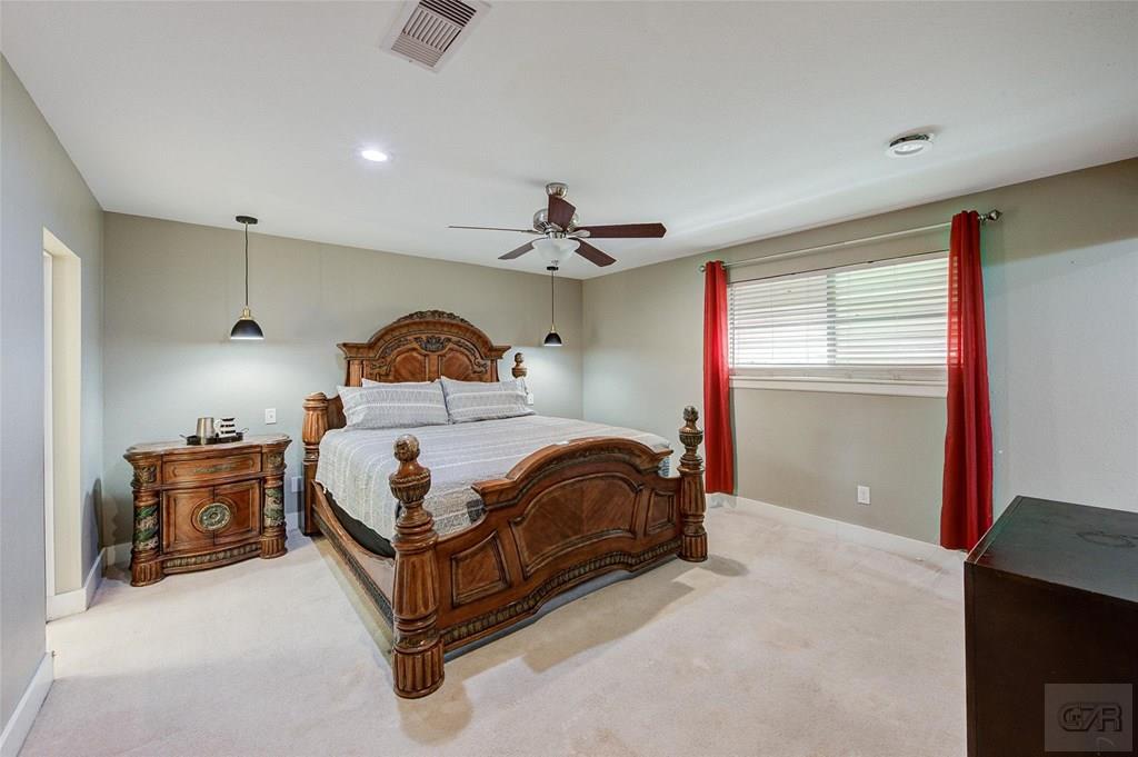 10213 Stewart Road Galveston, TX 77554 - Photo 31 of 49 a bedroom with a bed and window