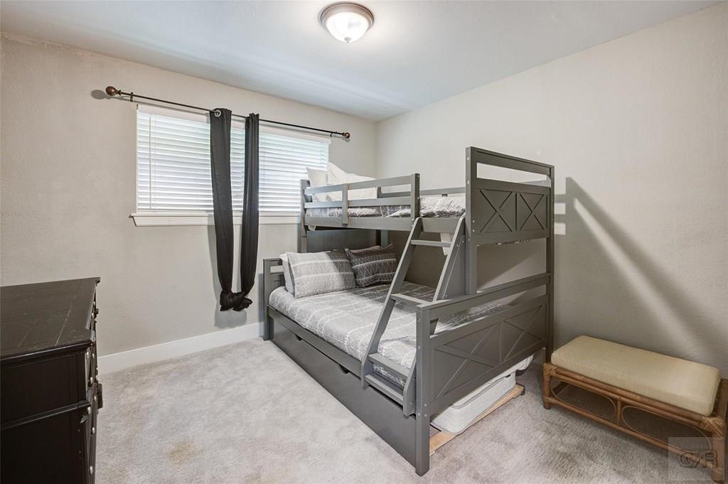 10213 Stewart Road Galveston, TX 77554 - Photo 35 of 49 a bedroom with a bed and a chair