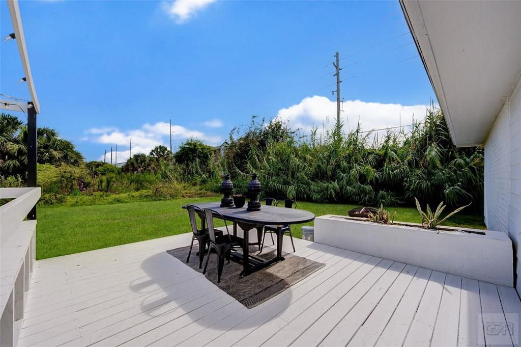 10213 Stewart Road Galveston, TX 77554 - Photo 41 of 49 a view of a deck with wooden floor and outdoor seating