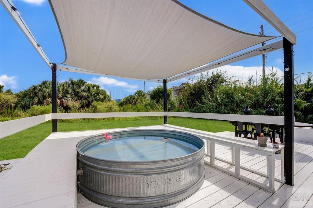 10213 Stewart Road Galveston, TX 77554 - Photo 42 of 49 a view of a swimming pool with a porch