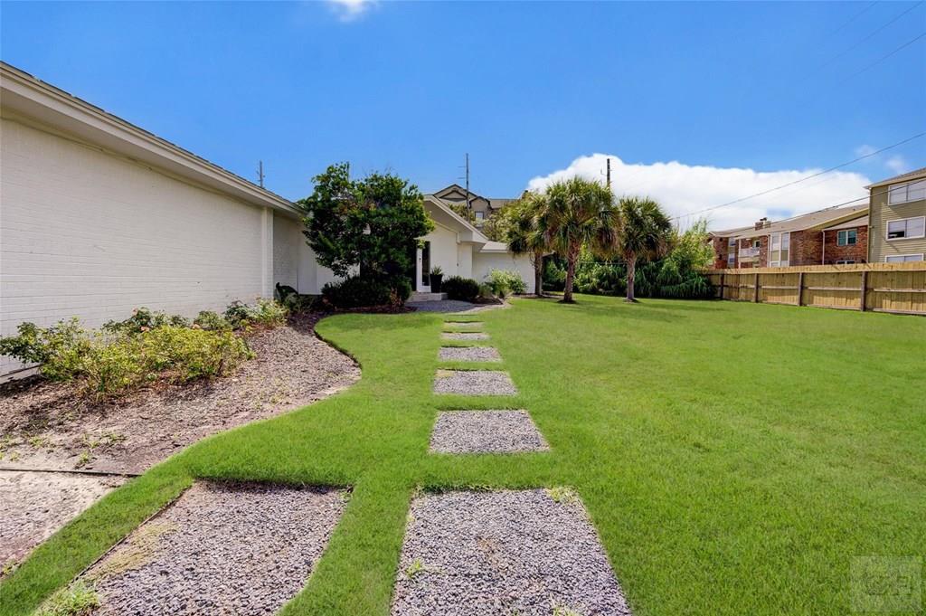 10213 Stewart Road Galveston, TX 77554 - Photo 49 of 49 a front view of a house with a yard