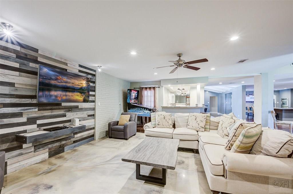 10213 Stewart Road Galveston, TX 77554 - Photo 5 of 49 a living room with furniture and a flat screen tv
