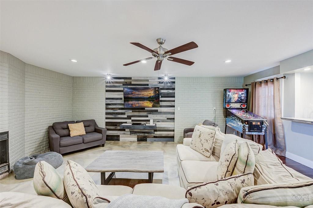 10213 Stewart Road Galveston, TX 77554 - Photo 7 of 49 a living room with furniture and a flat screen tv