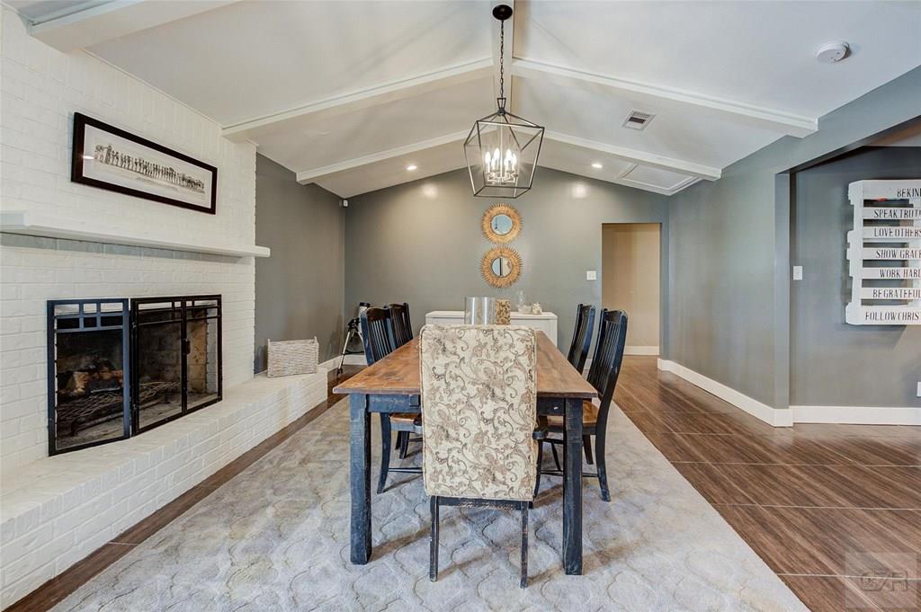 10213 Stewart Road Galveston, TX 77554 - Photo 10 of 49 a view of a dining room with furniture wooden floor fireplace and a chandelier