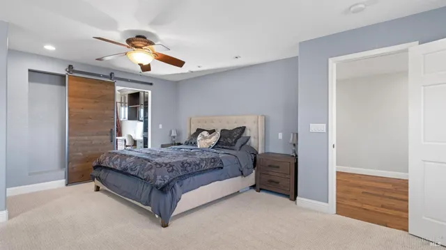a view of a patio with table and chairs potted plants with wooden floor and fence