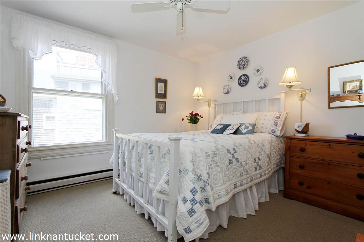 8 C Cliff Road, Unit C Nantucket, MA 02554 - Photo 12 of 20 a bed room with a bed and a window