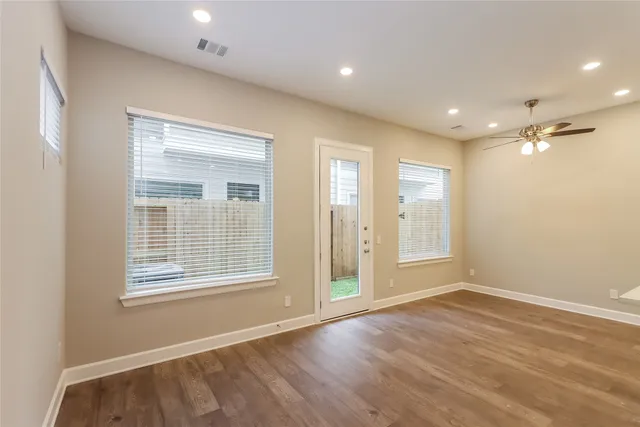 a view of a kitchen with kitchen island a sink stainless steel appliances and cabinets