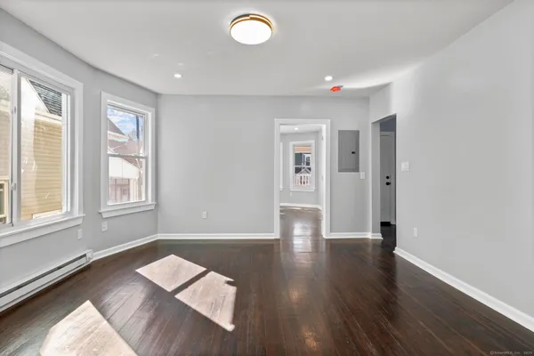wooden floor in an empty room with a window