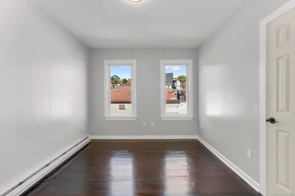 wooden floor in an empty room with a window
