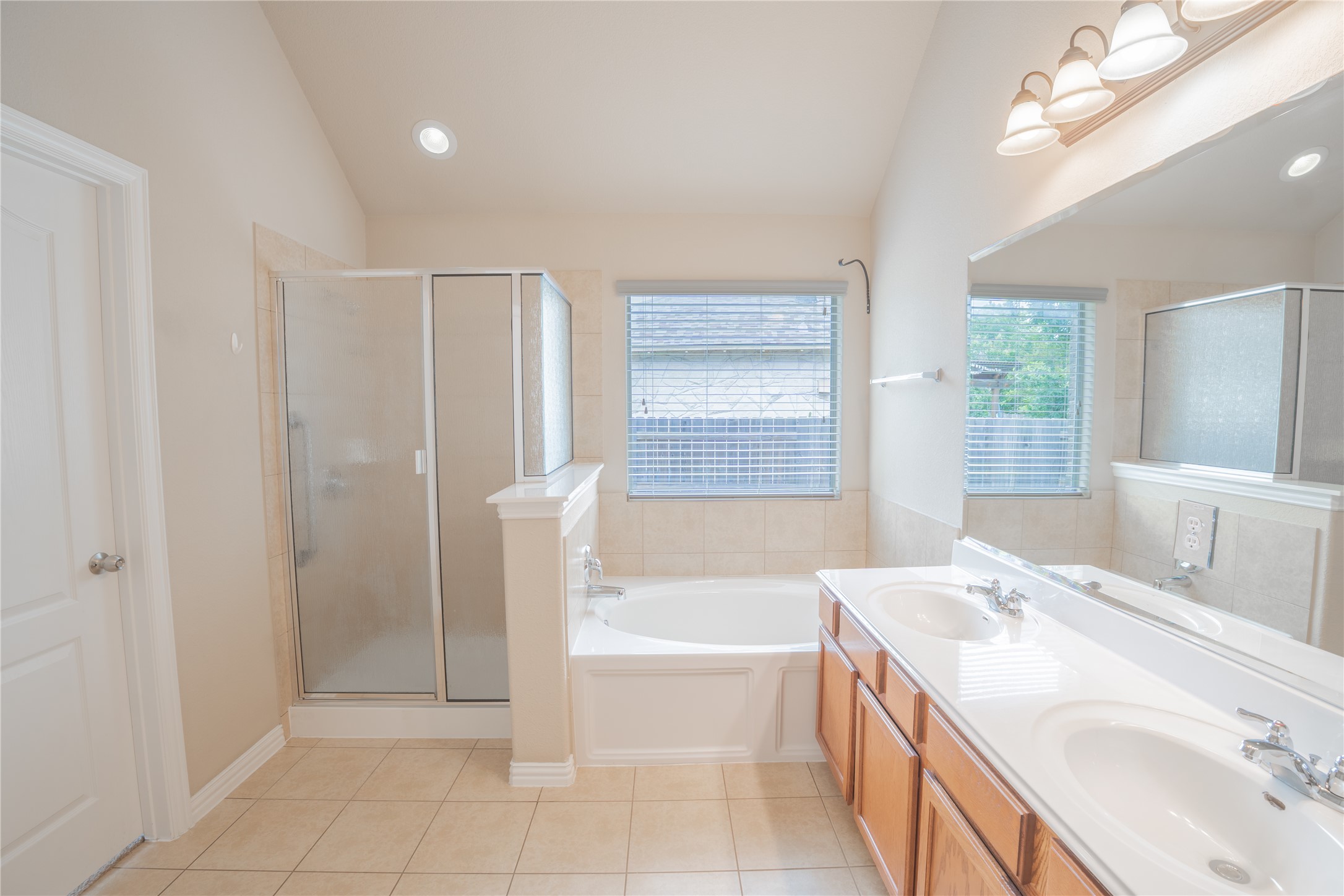 403 Tascate Street Georgetown, TX 78628 - Photo 12 of 26 Indulge in a primary bathroom offering both a luxurious soaking tub and a separate glass-enclosed shower.