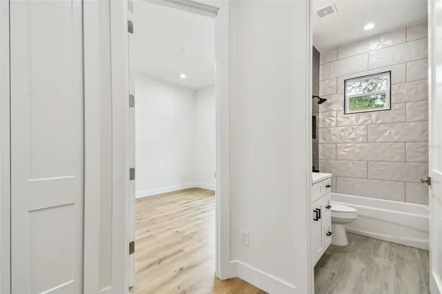 a bathroom with a tub and toilet