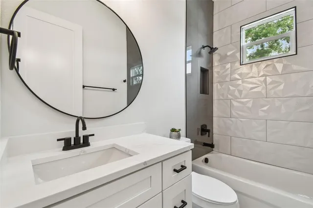 a bathroom with a sink a toilet and a mirror