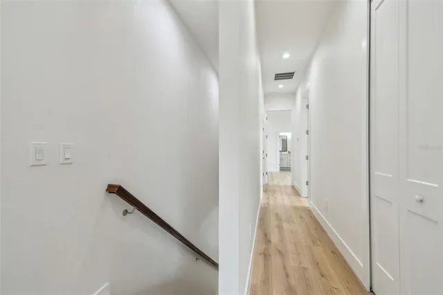 a view of hallway with wooden floor